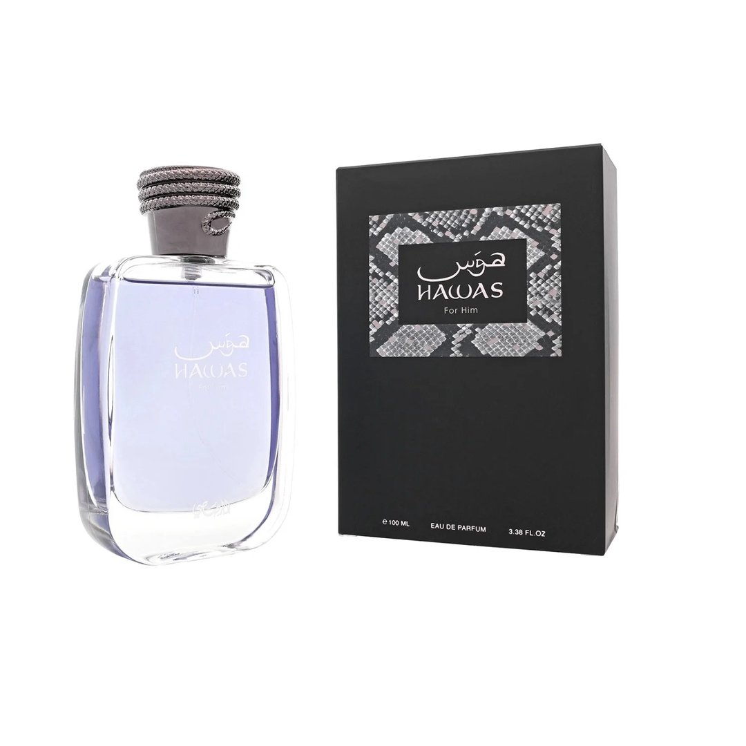 Rasasi Hawas For Him Eau De Parfum 100ml by Rasasi — A clear glass perfume bottle with purple liquid and a textured grey cap sits next to a black product box with a snakeskin pattern label. | Rasasi Hawas For Him Eau De Parfum 100ml by Rasasi — Botol minyak wangi kaca jernih dengan cecair ungu dan penutup kelabu