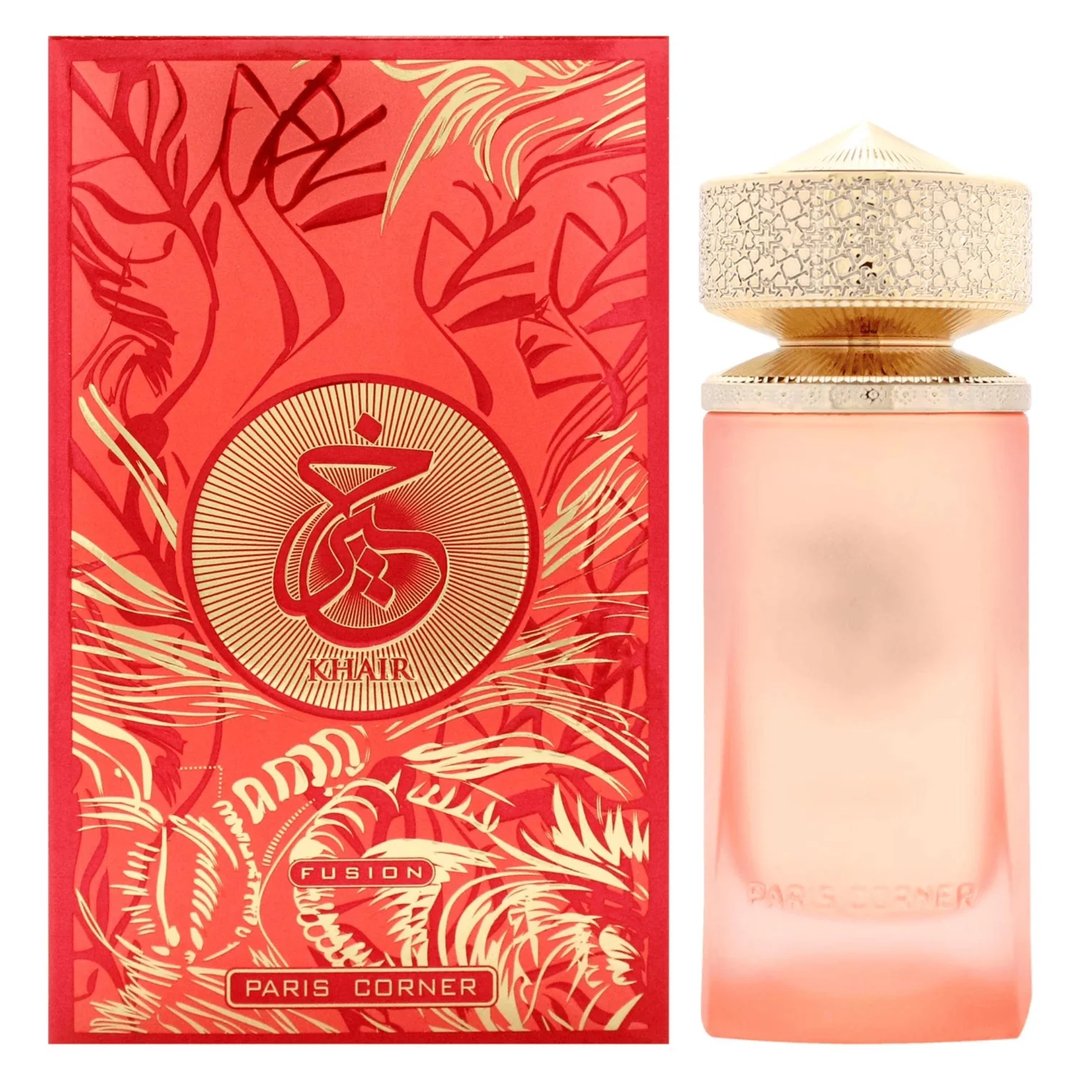 Paris Corner Khair Fusion Her 100ml — Red and gold patterned box next to a frosted pink perfume bottle with a gold textured cap. | Paris Corner Khair Fusion Her 100ml — Kotak corak merah dan emas di sebelah botol minyak wangi merah jambu beku dengan penutup bertekstur emas.