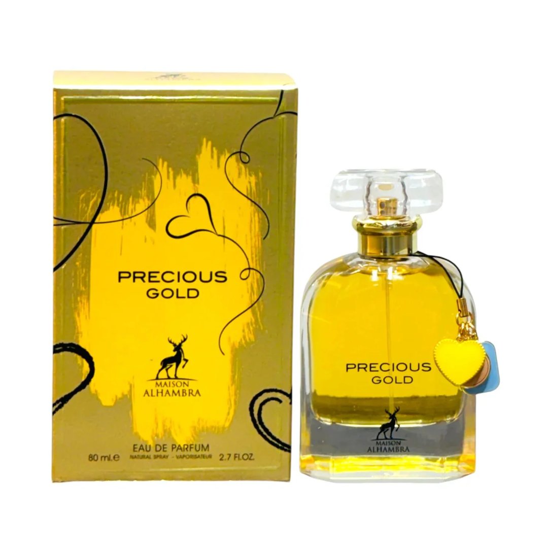 Maison Alhambra Precious Gold 80ml by Maison Alhambra — A gold-themed perfume box and bottle are displayed side-by-side against a white background. The box features abstract gold brushstrokes and a deer silhouette, while the bottle contains golden liquid and has a heart-shaped charm. | Maison Alhambra Precious Gold