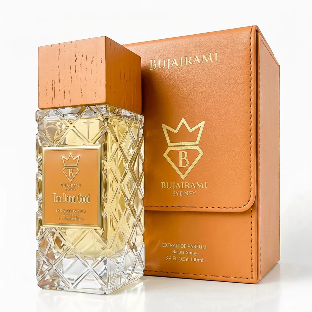 Bujairami Too Damn Good — Clear faceted glass perfume bottle with wooden cap next to orange leather box with gold logo