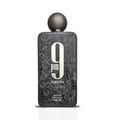 Afnan 9 PM Night Out Extrait de Parfum — A black textured perfume bottle with a dark textured cap stands next to its matching black textured box, both featuring a large white '9 PM Night Out' logo. | Afnan 9 PM Night Out Extrait de Parfum — Botol minyak wangi bertekstur hitam dengan penutup bertekstur gelap berdiri di