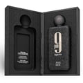 Afnan 9 PM Night Out Extrait de Parfum — A black textured perfume bottle with a dark textured cap stands next to its matching black textured box, both featuring a large white '9 PM Night Out' logo. | Afnan 9 PM Night Out Extrait de Parfum — Botol minyak wangi bertekstur hitam dengan penutup bertekstur gelap berdiri di