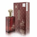 Ard Al Zaafaran Ahlam Al Khaleej 80ml by Ard Al Zaafaran — A red perfume box with gold intricate patterns and a matching red perfume bottle with a gold cap, displayed side-by-side on a white reflective surface. | Ard Al Zaafaran Ahlam Al Khaleej 80ml by Ard Al Zaafaran — Kotak minyak wangi merah dengan corak emas yang