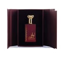 Ard Al Zaafaran Ahlam Al Khaleej 80ml by Ard Al Zaafaran — A red perfume box with gold intricate patterns and a matching red perfume bottle with a gold cap, displayed side-by-side on a white reflective surface. | Ard Al Zaafaran Ahlam Al Khaleej 80ml by Ard Al Zaafaran — Kotak minyak wangi merah dengan corak emas yang