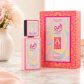 Lattafa Ajwad Pink 2 Pink Creamy Elixir EDP — Pink rectangular bottle with a colorful wavy pattern, topped with a smaller black cap featuring a similar wavy design and gold accents.