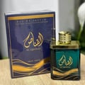 Ard Al Zaafaran Al Qannas Eau De Parfum 100ml — A blue perfume bottle and its matching blue box with gold Arabic calligraphy and wavy lines, displayed side-by-side on a white background. | Ard Al Zaafaran Al Qannas Eau De Parfum 100ml — Botol minyak wangi biru dan kotak birunya yang sepadan dengan kaligrafi Arab emas