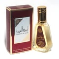 Ard Al Zaafaran Ameerat Al Arab Princess of Arabia 50ml — A red and gold perfume box stands next to a clear glass perfume bottle with a gold cap and a red label. | Ard Al Zaafaran Ameerat Al Arab Princess of Arabia 50ml — Kotak minyak wangi merah dan emas berdiri di sebelah botol minyak wangi kaca jernih dengan