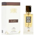 Lattafa Ana Abiyedh Leather 60ml by Lattafa Perfumes — A white perfume box with gold Arabic calligraphy and a clear glass bottle with gold accents and a dark brown cap, displayed side-by-side. | Lattafa Ana Abiyedh Leather 60ml by Lattafa Perfumes — Kotak minyak wangi putih dengan kaligrafi Arab emas dan botol kaca