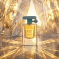 Lattafa Atlas Glacial Valley — A light blue textured box stands next to a clear glass perfume bottle with a light yellow liquid. The box has green vertical stripes and a tree graphic. The bottle has a teal cap with a tree charm.