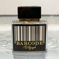 Paris Corner Autograph 100ml — A perfume bottle and its box are displayed side-by-side against a white background. Both feature a barcode design and the text "BARCODE Autograph" in gold lettering. | Paris Corner Autograph 100ml — Sebotol minyak wangi dan kotaknya dipamerkan bersebelahan di atas latar belakang putih.