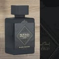 Lattafa Badee Al Oud Lattafa Black Exposed 100ml — Black perfume bottle and its gold-accented box, displayed side-by-side on a white background.