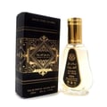 Ard Al Zaafaran Badee Al Oud Eau De Parfum 50ml — Black and gold geometric patterned box next to a clear glass perfume bottle with a gold cap, on a white background. | Ard Al Zaafaran Badee Al Oud Eau De Parfum 50ml — Kotak hitam dan emas bercorak geometri di sebelah botol minyak wangi kaca jernih bertudung emas, di