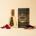 Ard Al Zaafaran Badee Al Oud Eau De Parfum 50ml — Black and gold geometric patterned box next to a clear glass perfume bottle with a gold cap, on a white background. | Ard Al Zaafaran Badee Al Oud Eau De Parfum 50ml — Kotak hitam dan emas bercorak geometri di sebelah botol minyak wangi kaca jernih bertudung emas, di