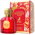 Maison Alhambra Baroque Rouge Extrait 100ml by Maison Alhambra — Red faceted glass perfume bottle with gold cap next to a red and gold ornate box with a bird and deer motif | Maison Alhambra Baroque Rouge Extrait 100ml by Maison Alhambra — Botol kaca merah berfaset dengan penutup emas di sebelah kotak merah dan emas