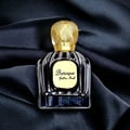 Maison Alhambra Baroque Satin Oud 100ml — A dark glass perfume bottle with a gold textured cap sits next to its matching dark box with gold geometric patterns. | Maison Alhambra Baroque Satin Oud 100ml — Botol minyak wangi kaca gelap dengan penutup bertekstur emas terletak di sebelah kotak gelapnya dengan corak