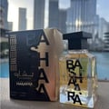Ard Al Zaafaran Bashaara Eau De Parfum 100ml — Clear glass bottle with yellow liquid and black text "BA SHAARA" repeated vertically, black wooden cap | Ard Al Zaafaran Bashaara Eau De Parfum 100ml — Botol kaca jernih dengan cecair kuning dan teks hitam "BA SHAARA" berulang secara menegak, penutup kayu hitam