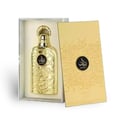 Lattafa Bayaan Eau De Parfum — A gold-colored perfume bottle with ornate Arabic script and a gold ring handle sits next to its matching gold box, also adorned with script and a circular logo. | Lattafa Bayaan Eau De Parfum — Botol minyak wangi berwarna emas dengan skrip Arab berhias dan pemegang cincin emas duduk