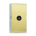 Lattafa Bayaan Eau De Parfum — A gold-colored perfume bottle with ornate Arabic script and a gold ring handle sits next to its matching gold box, also adorned with script and a circular logo. | Lattafa Bayaan Eau De Parfum — Botol minyak wangi berwarna emas dengan skrip Arab berhias dan pemegang cincin emas duduk