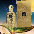 Lattafa Bayaan Eau De Parfum — A gold-colored perfume bottle with ornate Arabic script and a gold ring handle sits next to its matching gold box, also adorned with script and a circular logo. | Lattafa Bayaan Eau De Parfum — Botol minyak wangi berwarna emas dengan skrip Arab berhias dan pemegang cincin emas duduk
