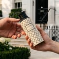 Maison Asrar Belgravia by Maison Asrar Eau de Parfum — A cream-colored perfume bottle with a black patterned design and a black textured cap, featuring a black label with white text 'BELGRAVIA ROYAL COLLECTION'.