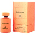 Grandeur Blush Amber 100ml — An orange perfume bottle and its matching orange box with geometric patterns, displayed side-by-side against a white background. | Grandeur Blush Amber 100ml — Botol minyak wangi oren dan kotak orennya yang sepadan dengan corak geometri, dipaparkan bersebelahan di atas latar belakang putih.
