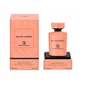 Grandeur Blush Amber 100ml — An orange perfume bottle and its matching orange box with geometric patterns, displayed side-by-side against a white background. | Grandeur Blush Amber 100ml — Botol minyak wangi oren dan kotak orennya yang sepadan dengan corak geometri, dipaparkan bersebelahan di atas latar belakang putih.