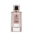 Maison Alhambra Chic Velvet Pink Secret for Women 100ml — A pink cylindrical box stands next to a clear glass perfume bottle with a black cap and gold accents. The box and bottle label feature a deer silhouette and text. | Maison Alhambra Chic Velvet Pink Secret for Women 100ml — Kotak silinder merah jambu berdiri di
