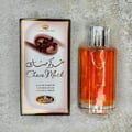 Al Rehab Choco Musk — A perfume box and bottle are displayed against a white background. The box is brown and white with floral and text details. The clear glass bottle contains amber liquid. | Al Rehab Choco Musk — Kotak dan botol minyak wangi dipaparkan berlatarkan putih. Kotak berwarna coklat dan putih dengan
