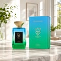 Bujairami Chroma — Blue-green gradient glass perfume bottle with gold cap next to matching gradient box.