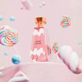 Khadlaj Cloud Candy Eau De Parfum 100ml — A pink perfume box with cloud graphics sits next to a clear glass perfume bottle with cloud-like white accents and a gold cap, both featuring the 'Cloud Candy' logo. | Khadlaj Cloud Candy Eau De Parfum 100ml — Kotak minyak wangi merah jambu dengan grafik awan duduk di sebelah