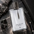 Armaf Club de Nuit Precieux II — Black textured box with silver text and a clear glass perfume bottle with a silver chain and charm.