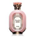 Zimaya Daiman Eden Eau De Parfum 100ml by Zimaya — A pink textured perfume bottle with gold accents stands next to its matching coral-orange textured box with gold marbling. | Zimaya Daiman Eden Eau De Parfum 100ml by Zimaya — Sebotol minyak wangi merah jambu bertekstur dengan perincian emas berdiri di sebelah kotak