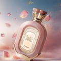 Zimaya Daiman Eden Eau De Parfum 100ml by Zimaya — A pink textured perfume bottle with gold accents stands next to its matching coral-orange textured box with gold marbling. | Zimaya Daiman Eden Eau De Parfum 100ml by Zimaya — Sebotol minyak wangi merah jambu bertekstur dengan perincian emas berdiri di sebelah kotak