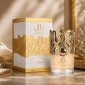 Lattafa Dalal Lattafa 100ml Women — Perfume bottle with ornate gold filigree cap, adorned with rhinestones, next to its white and gold box with matching filigree design.