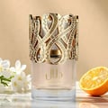 Lattafa Dalal Lattafa 100ml Women — Perfume bottle with ornate gold filigree cap, adorned with rhinestones, next to its white and gold box with matching filigree design.