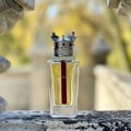 Lattafa Dynasty Lattafa 100ml EDP Unisex — A maroon textured box with a white ornate crest sits next to a clear glass perfume bottle topped with a silver crown-shaped cap with red accents.