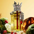 Lattafa Dynasty Lattafa 100ml EDP Unisex — A maroon textured box with a white ornate crest sits next to a clear glass perfume bottle topped with a silver crown-shaped cap with red accents.