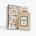 Maison Alhambra Floral Bloom — A beige perfume bottle with a peach cap stands next to its matching beige box, both featuring floral and deer motifs. | Maison Alhambra Floral Bloom — Botol minyak wangi berwarna krim dengan penutup pic berdiri di sebelah kotak sepadan berwarna krim, kedua-duanya menampilkan motif bunga