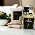 Maison Alhambra Florenza 100ml Maison Alhambra Florence — A perfume bottle and its box are displayed against a white background. The box has a floral design and the bottle is octagonal with a black ribbon. | Maison Alhambra Florenza 100ml Maison Alhambra Florence — Botol minyak wangi dan kotaknya dipamerkan berlatar