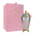 Zimaya Ghali Elegant Eau De Parfum 100ml by Zimaya — A pink patterned box with building facade design stands next to a fluted glass perfume bottle with a gold base and a pink tassel on the cap. | Zimaya Ghali Elegant Eau De Parfum 100ml oleh Zimaya — Peti merah jambu bercorak dengan reka bentuk fasad bangunan berdiri