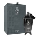 Zimaya Ghali Imperial Eau De Parfum — A dark grey textured box with a building facade pattern stands next to a dark, fluted perfume bottle with a tassel. | Zimaya Ghali Imperial Eau De Parfum — Kotak kelabu gelap bertekstur dengan corak fasad bangunan berdiri di sebelah botol minyak wangi gelap berlekuk dengan juntai.