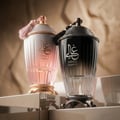 Zimaya Ghali Imperial Eau De Parfum — A dark grey textured box with a building facade pattern stands next to a dark, fluted perfume bottle with a tassel. | Zimaya Ghali Imperial Eau De Parfum — Kotak kelabu gelap bertekstur dengan corak fasad bangunan berdiri di sebelah botol minyak wangi gelap berlekuk dengan juntai.