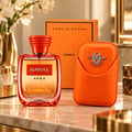 Kenz de Rasasi Hawas Apex — Botol minyak wangi oren bersama sarung bertekstur oren dengan lambang perak, di latar belakang putih.