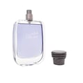 Rasasi Hawas For Him Eau De Parfum 100ml by Rasasi — A clear glass perfume bottle with purple liquid and a textured grey cap sits next to a black product box with a snakeskin pattern label. | Rasasi Hawas For Him Eau De Parfum 100ml by Rasasi — Botol minyak wangi kaca jernih dengan cecair ungu dan penutup kelabu