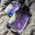 Rasasi Hawas For Him Eau De Parfum 100ml by Rasasi — A clear glass perfume bottle with purple liquid and a textured grey cap sits next to a black product box with a snakeskin pattern label. | Rasasi Hawas For Him Eau De Parfum 100ml by Rasasi — Botol minyak wangi kaca jernih dengan cecair ungu dan penutup kelabu