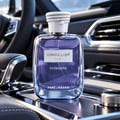 Kenz de Rasasi Hawas Ice Ultradose by Kenz de Rasasi 100ml Men — A clear glass perfume bottle with blue liquid, featuring a silver label with Arabic and English text, and a white rope-like cap.