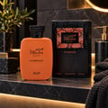 RASASI Hawas Overdose by Rasasi 100ml EDP — Orange perfume bottle with black textured cap next to its black and orange patterned box, both featuring the Hawas logo and text.