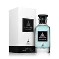 Maison Alhambra Jean Lowe Fantasme — Blue liquid in a clear glass bottle with a black cap, next to a white textured cylindrical box with black labels featuring a deer logo and text. | Maison Alhambra Jean Lowe Fantasme — Cecair biru dalam botol kaca jernih bertutup hitam, bersebelahan kotak silinder bertekstur putih