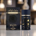 Lattafa Khalta Blend Of Lattafa Eau De Parfum 100ml — A dark blue perfume bottle with gold accents and a cutout design, next to its matching dark box and cap, all on a white reflective surface. | Lattafa Khalta Blend Of Lattafa Eau De Parfum 100ml — Botol minyak wangi biru gelap dengan aksen emas dan rekaan potongan
