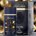 Lattafa Khalta Blend Of Lattafa Eau De Parfum 100ml — A dark blue perfume bottle with gold accents and a cutout design, next to its matching dark box and cap, all on a white reflective surface. | Lattafa Khalta Blend Of Lattafa Eau De Parfum 100ml — Botol minyak wangi biru gelap dengan aksen emas dan rekaan potongan